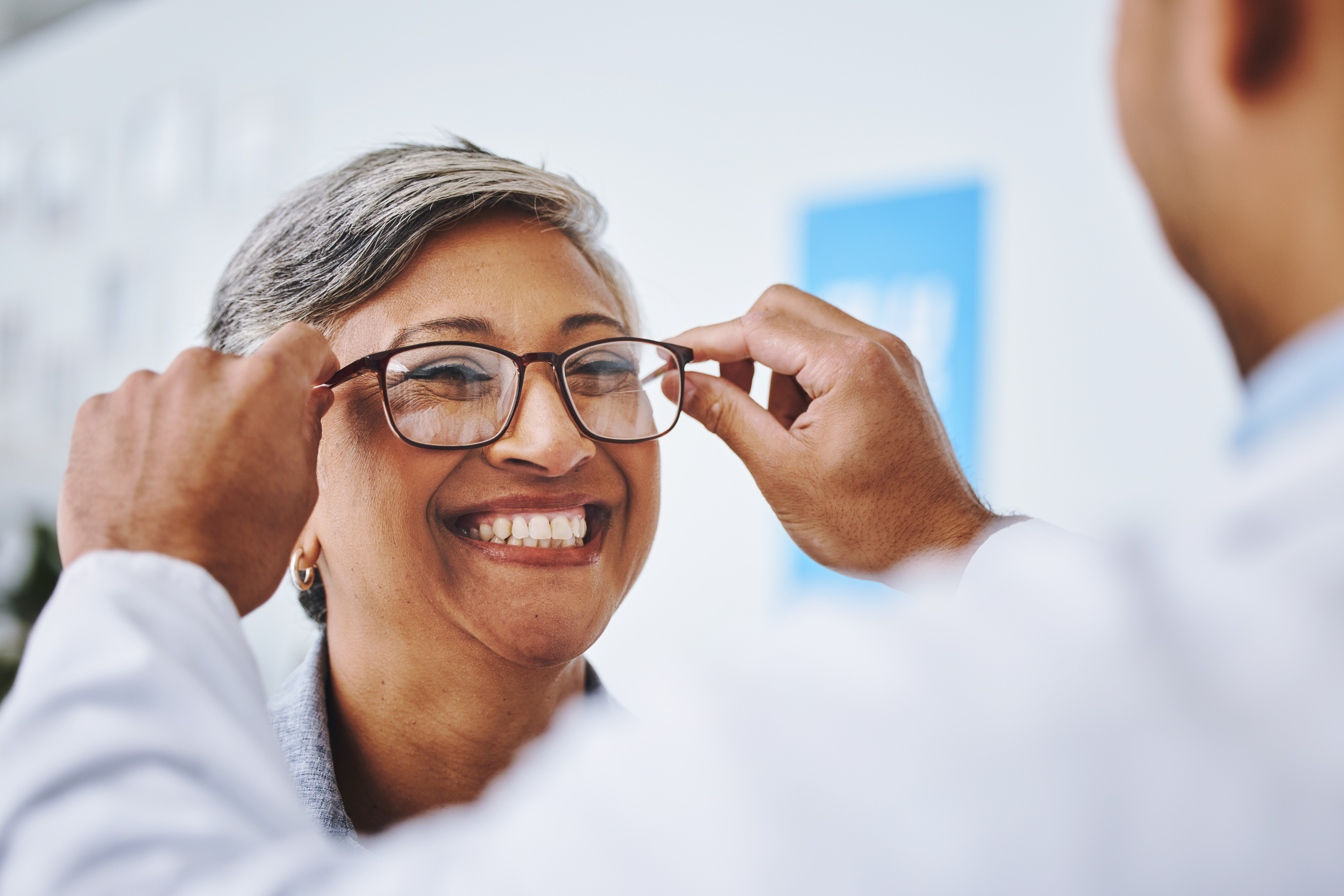 Happy patient being fitted for new glasses